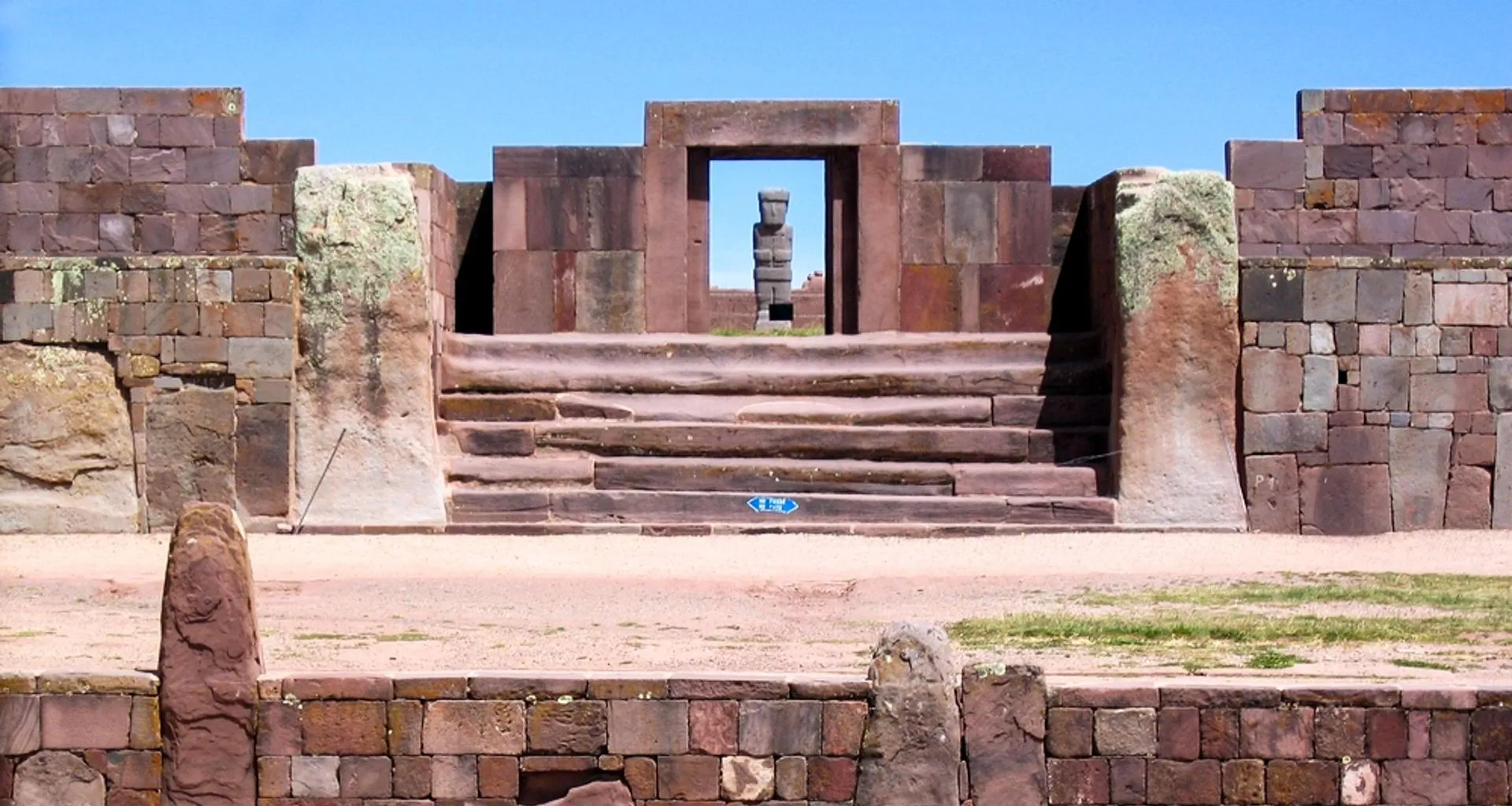 Statue stands in doorway of ruins
