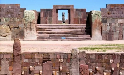 Statue stands in doorway of ruins