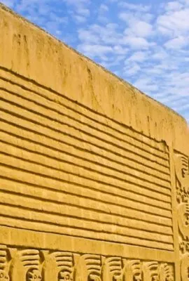 Statue near large stone wall