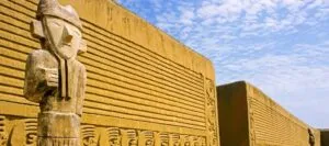 Statue near large stone wall