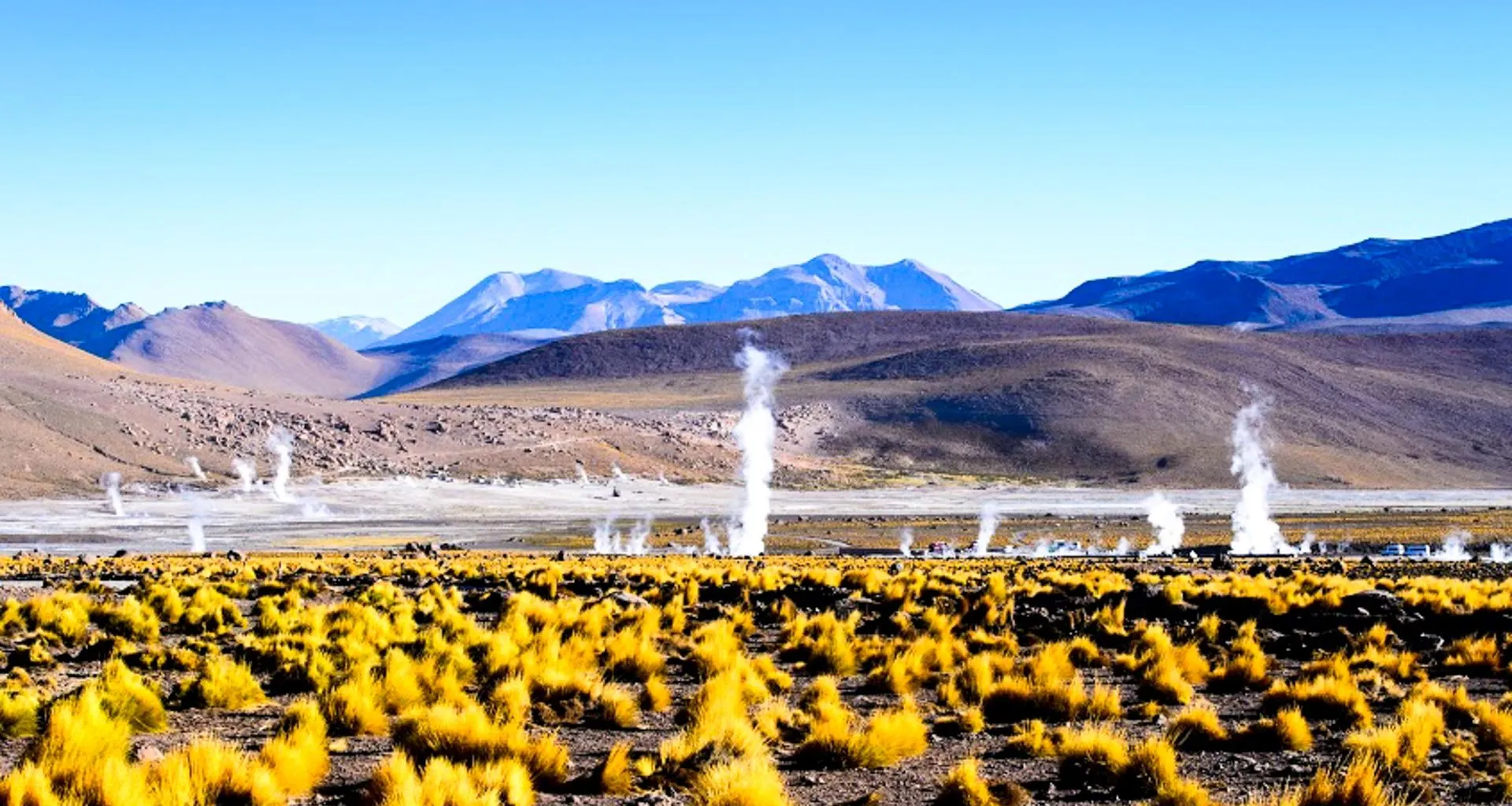 Steam vents on plain near mountains