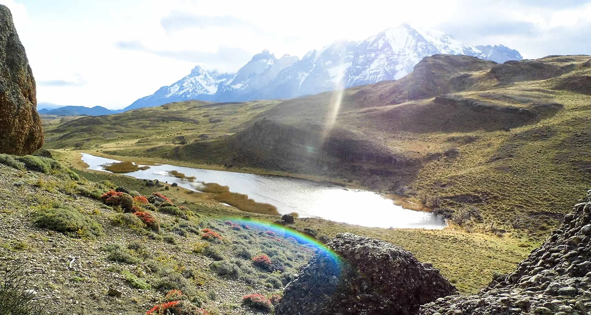 Sunlit valley between mountains