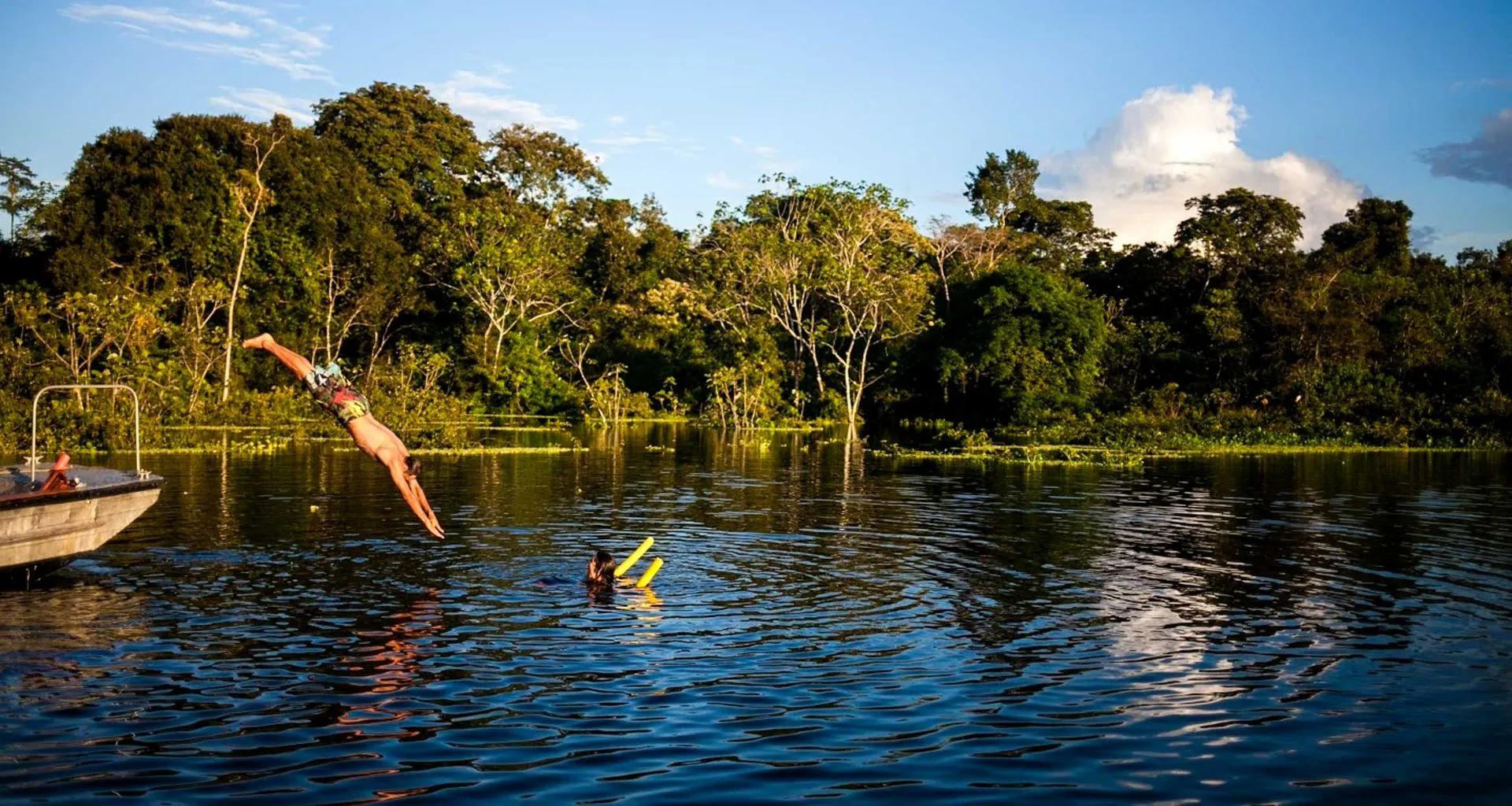 Traveler dives into Amazon river from cruise
