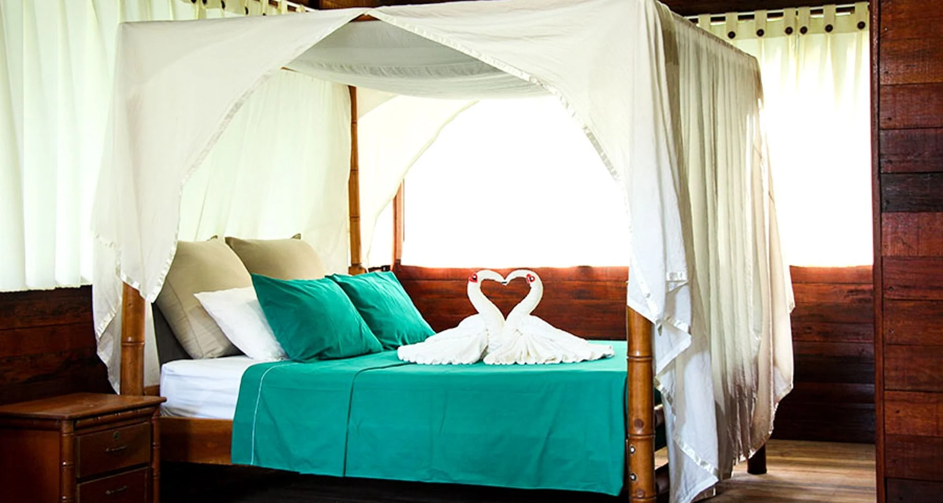 Towel swans on bed at Tahuayo Lodge