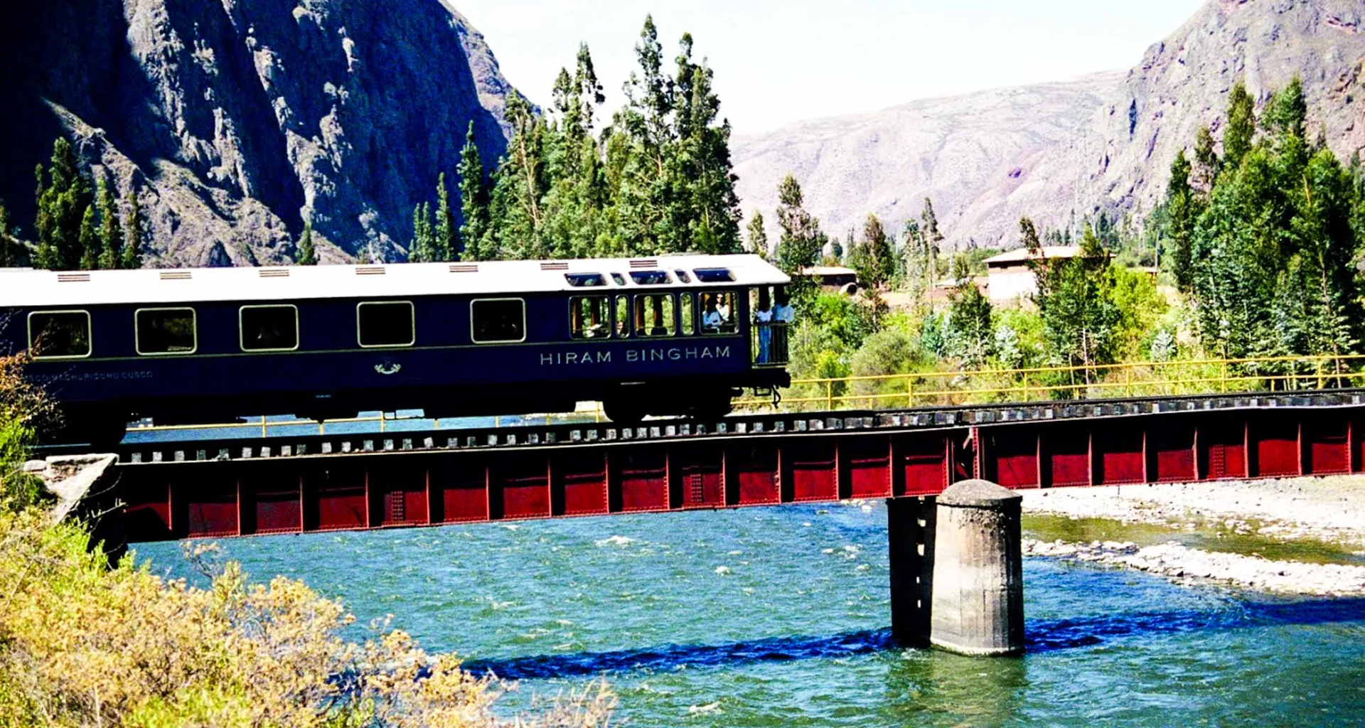 Train crosses small bridge over river