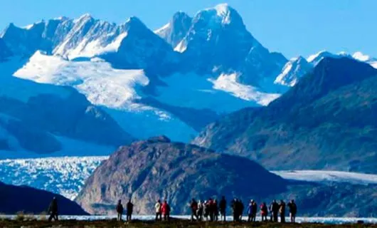 Travelers stand near Ainsworth Bay in South America