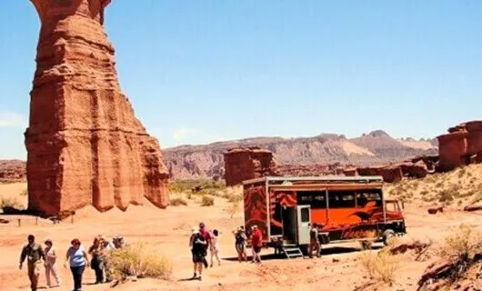 Red truck parked in desert