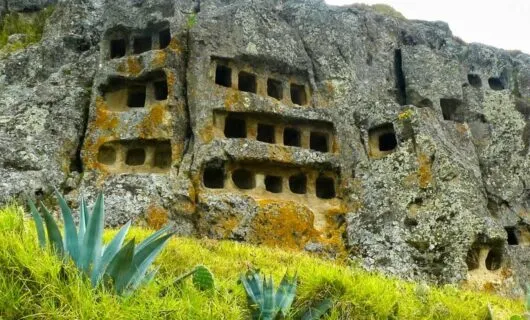 Square graves carved into volcanic rock
