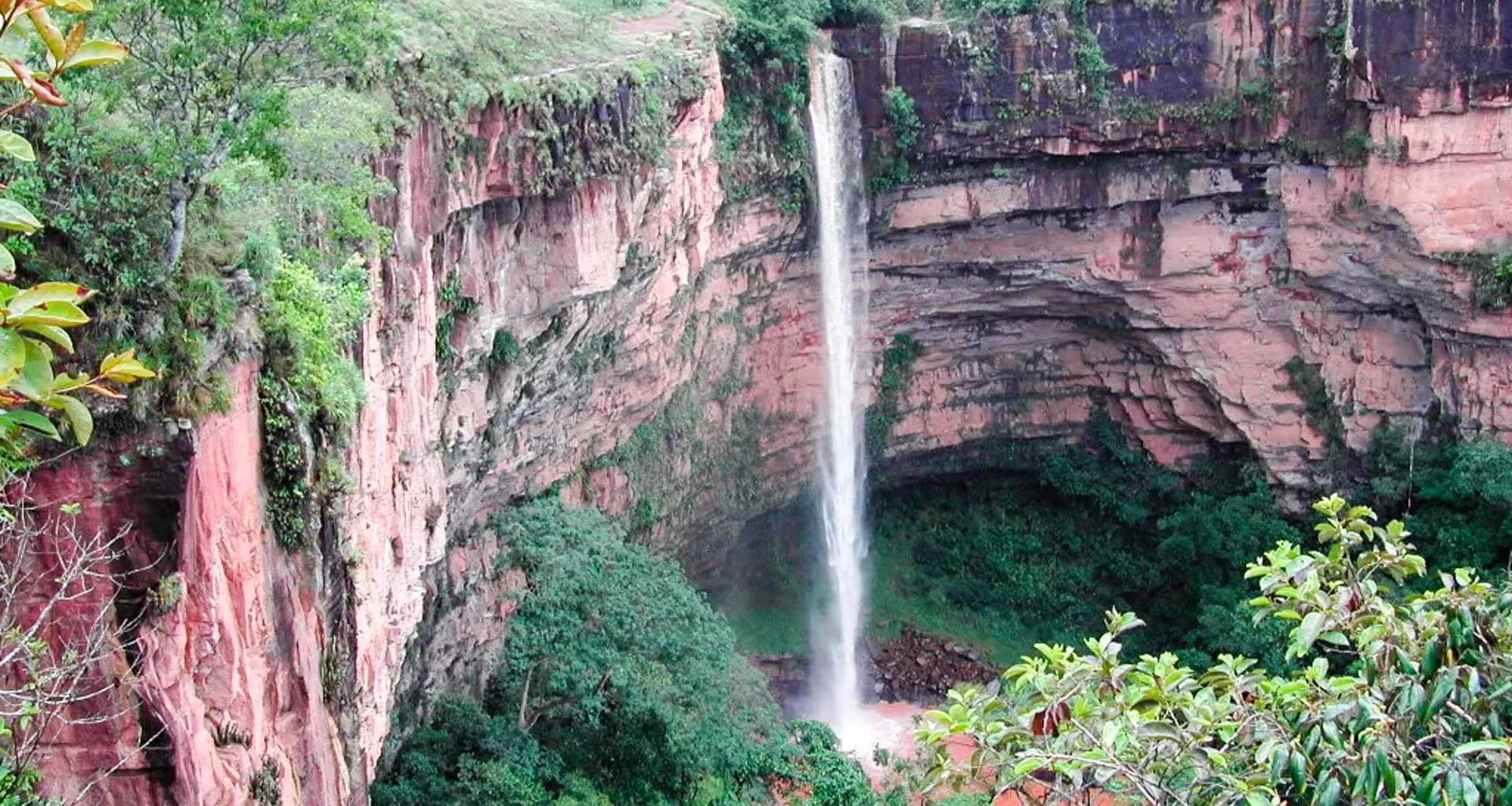 Waterfall runs down red rock