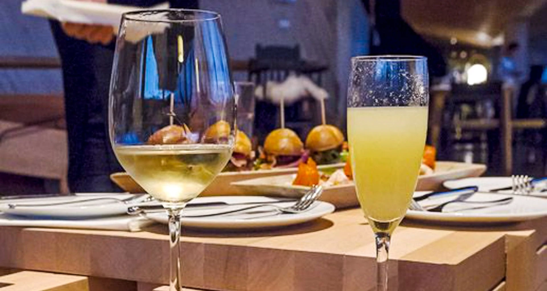 Wine glasses on table with meal set out