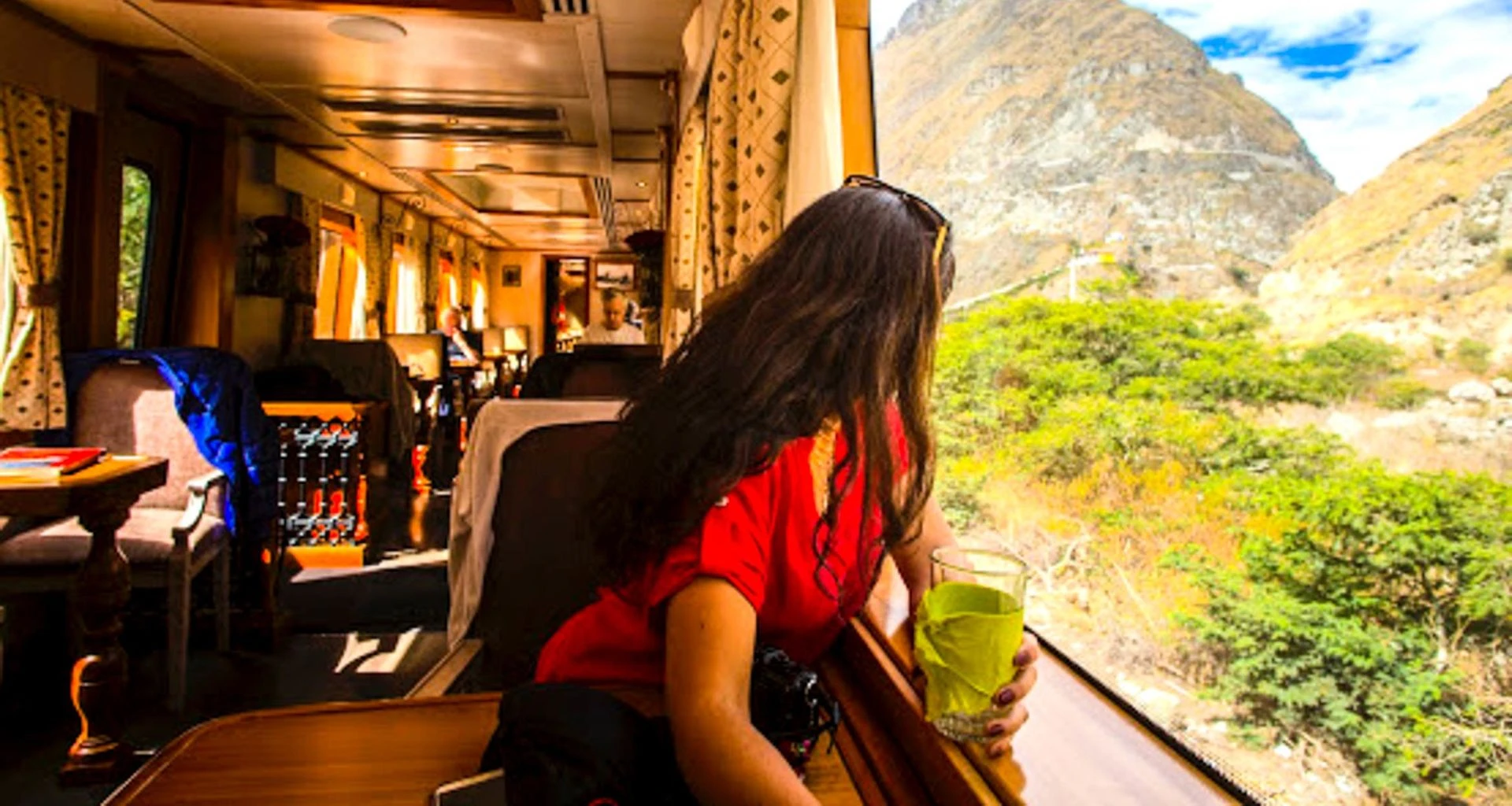 Woman leans into train window to see the view