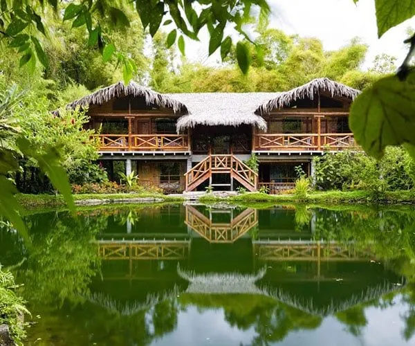 scenic Amazon Rainforest Lodge reflecting off pond