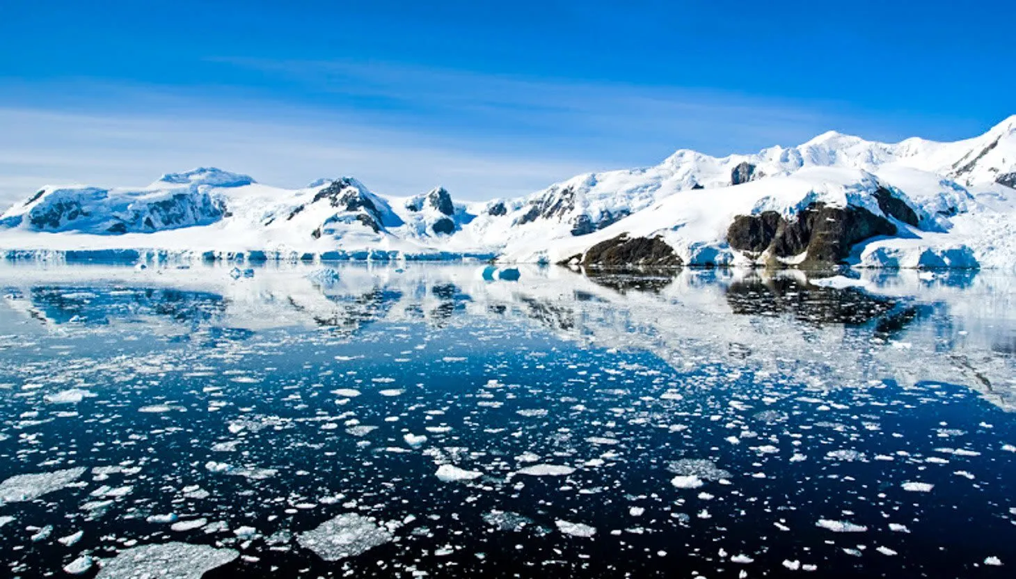 Antarctica mountains on edge of icy ocean bay