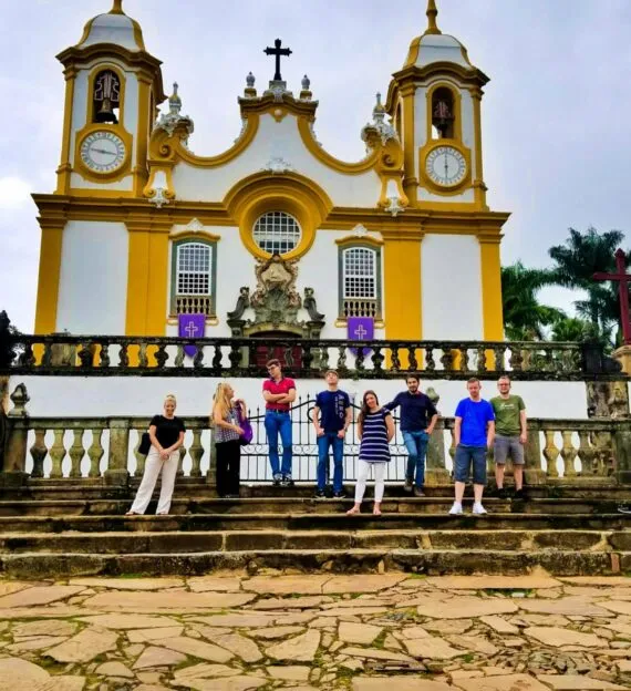 SAT team stands on steps in front of South America church