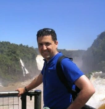 portrait of blake in front of a waterfall
