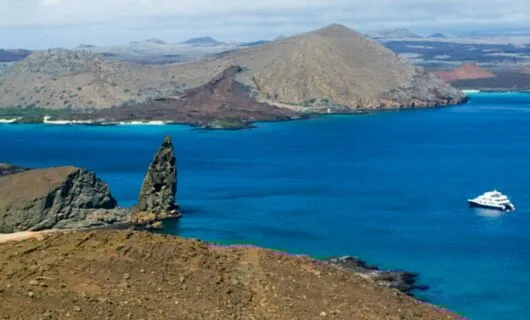Galapagos cruise ship passes Pinnacle Rock