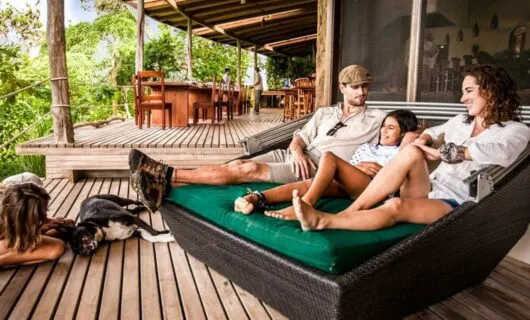 Family lounges on porch in Galapagos