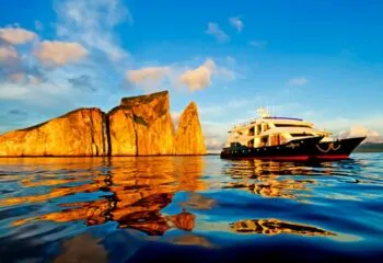 Ocean Spray cruise ship passes by island cliff