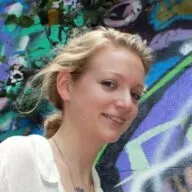 portrait of Katherine standing near a mural