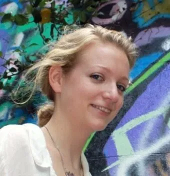 portrait of Katherine standing near a mural