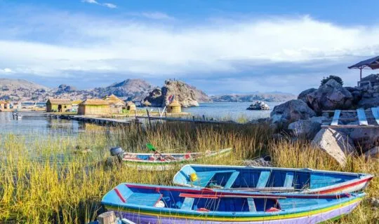 lake-titicaca-with-reed-houses-and-traditional-boats-on-shore