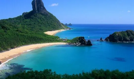 beautiful-island-beach-and-steep-mountain-rising-above-ocean