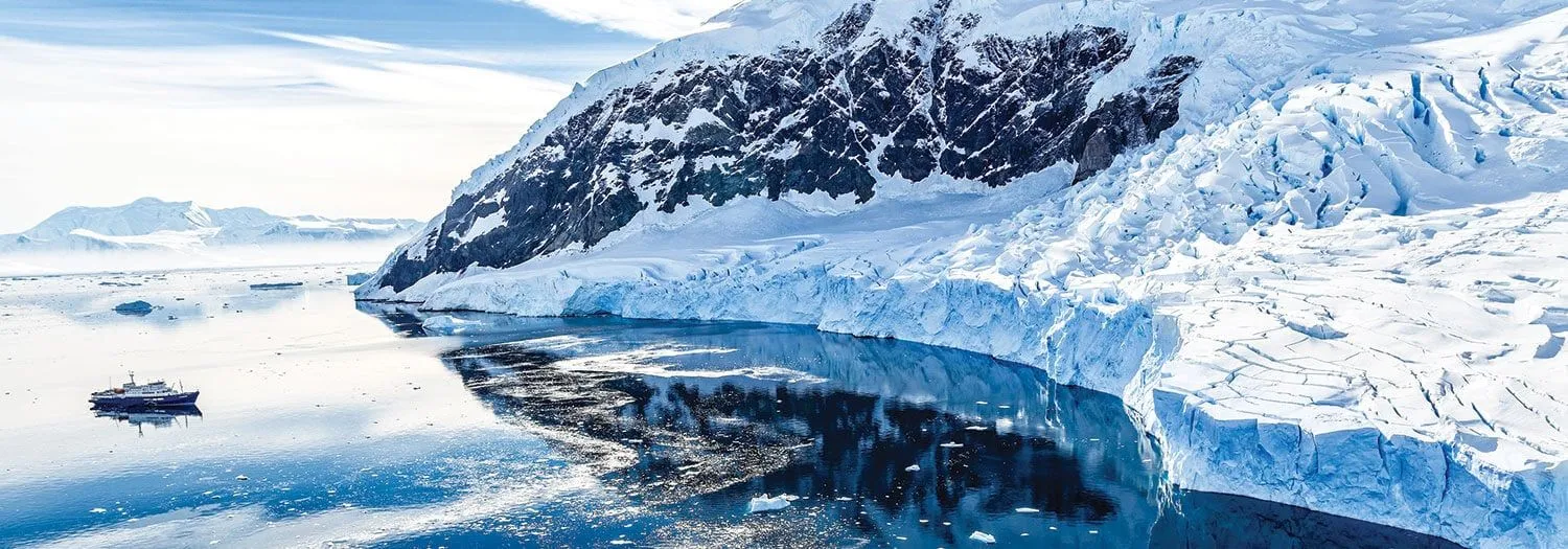 Boat exploring glaciers in Antarctica in the spring