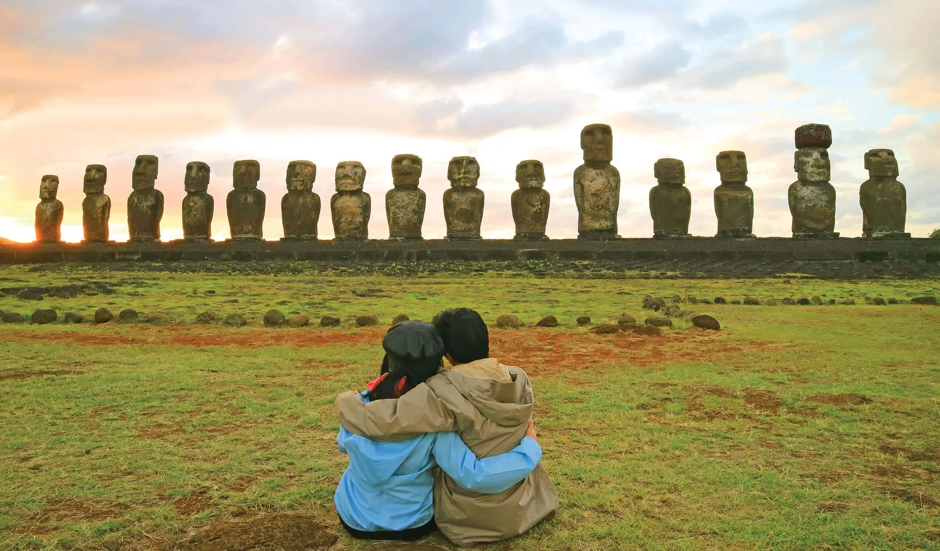 couple looking at the moais in easter island chile