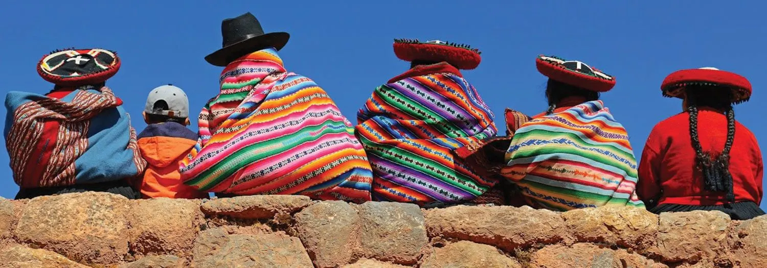 native people in Bolivia sitting on ruins in Winter