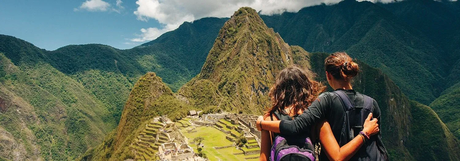 travelers at machu picchu during the rainy season in peru