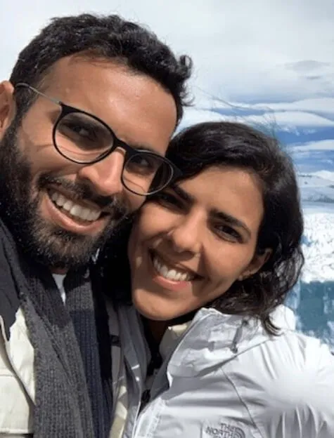 Young couple on their vacation in Patagonia with the Perito Moreno Glacier in the background