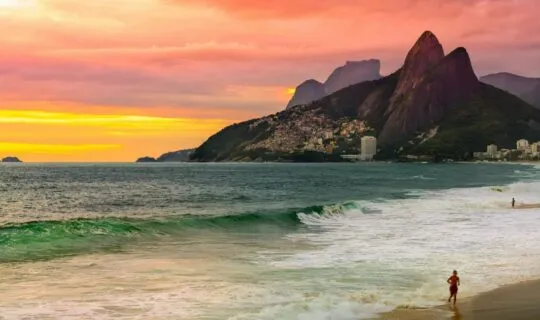 Man running on beach during sunset on Rio de Janeiro tour