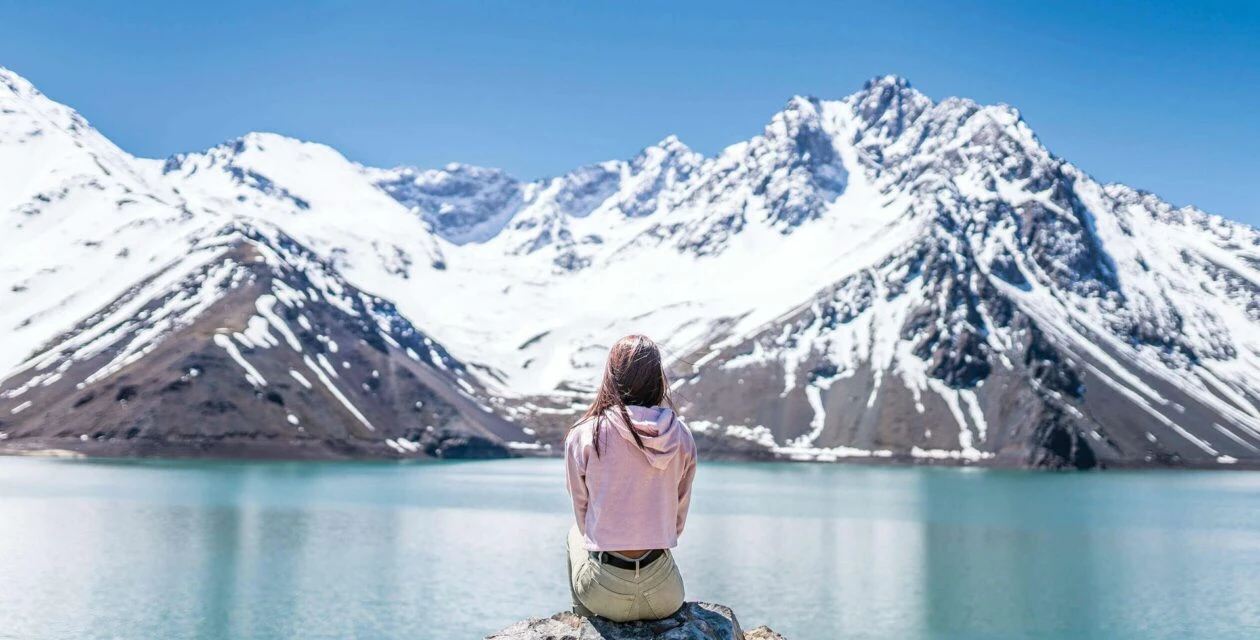 Woman sitting on a rock in the Chilean Mountain range