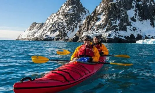 Travelers Kayaking around Antartica sites