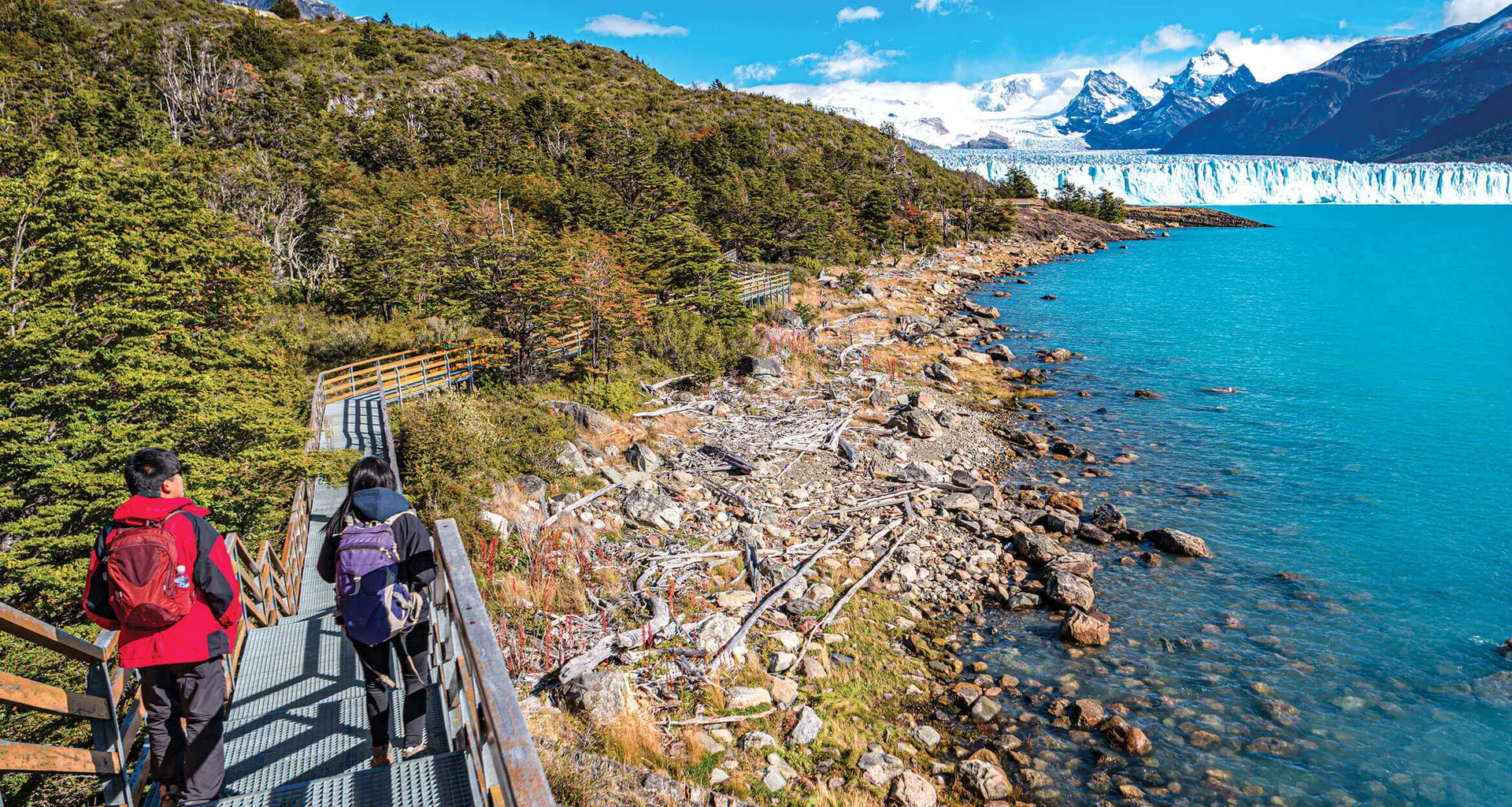travelers walking towards the perito moreno glacier