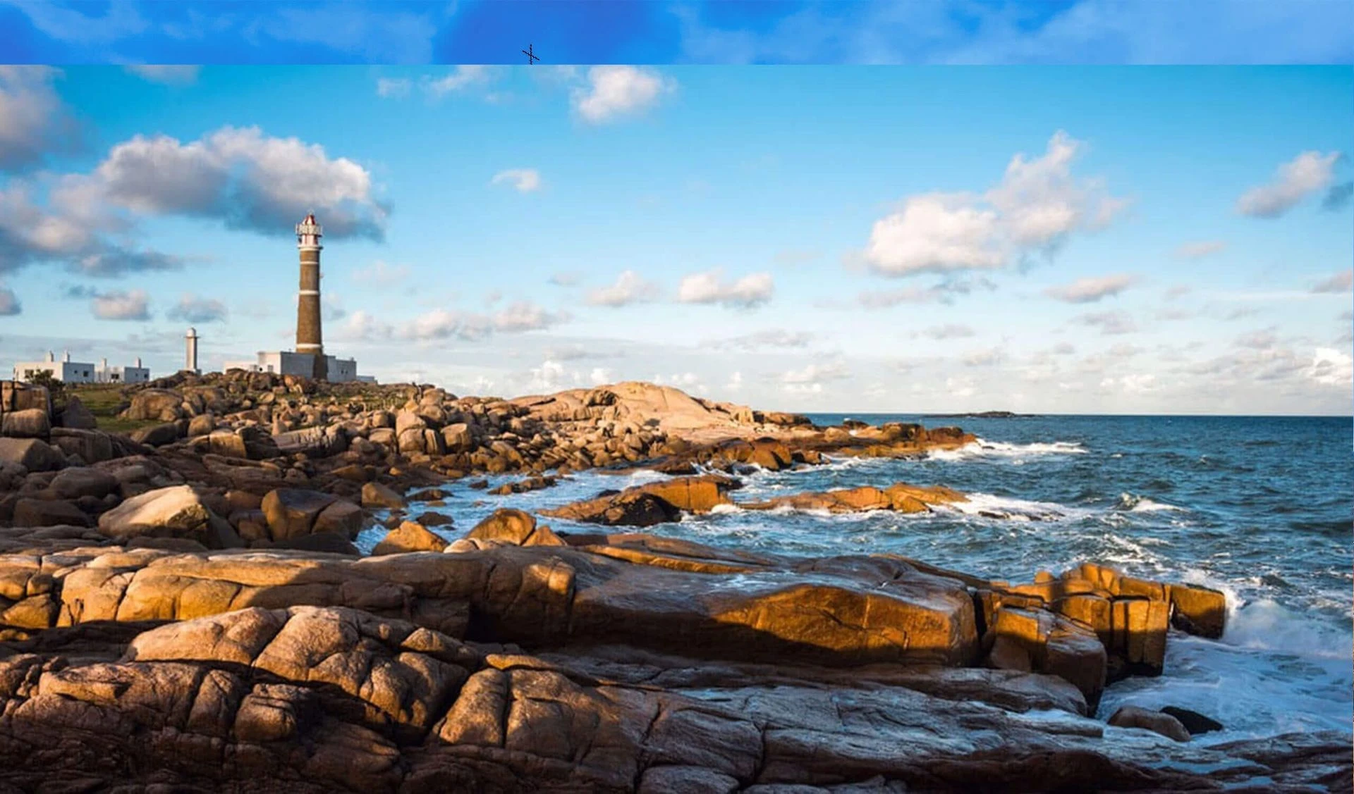 rocky beach and lighthouse uruguay
