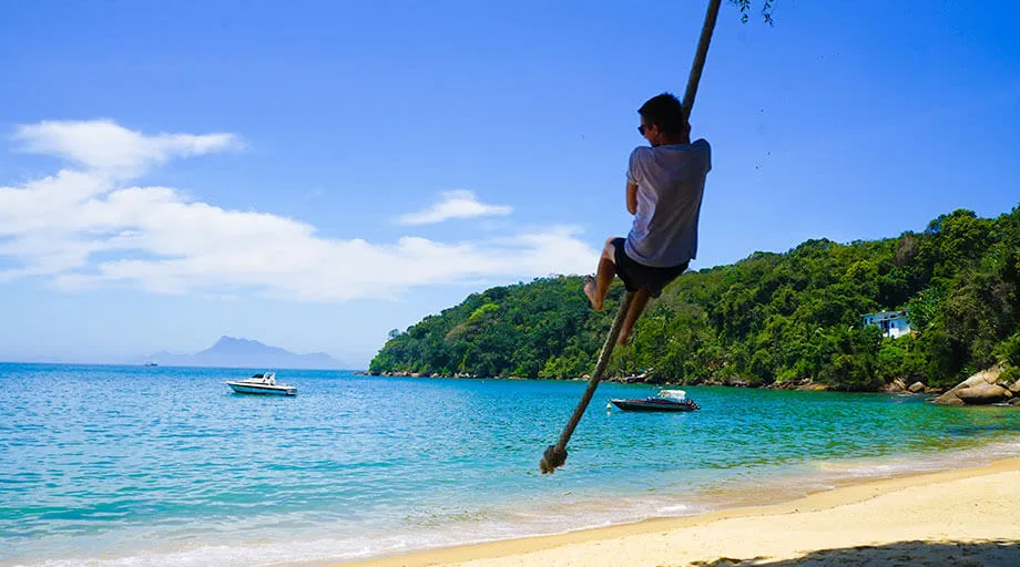 Man on tight rope in Ilha Grande Brazil