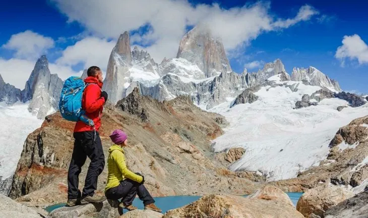 couple hiking in patagonia on a sunny day