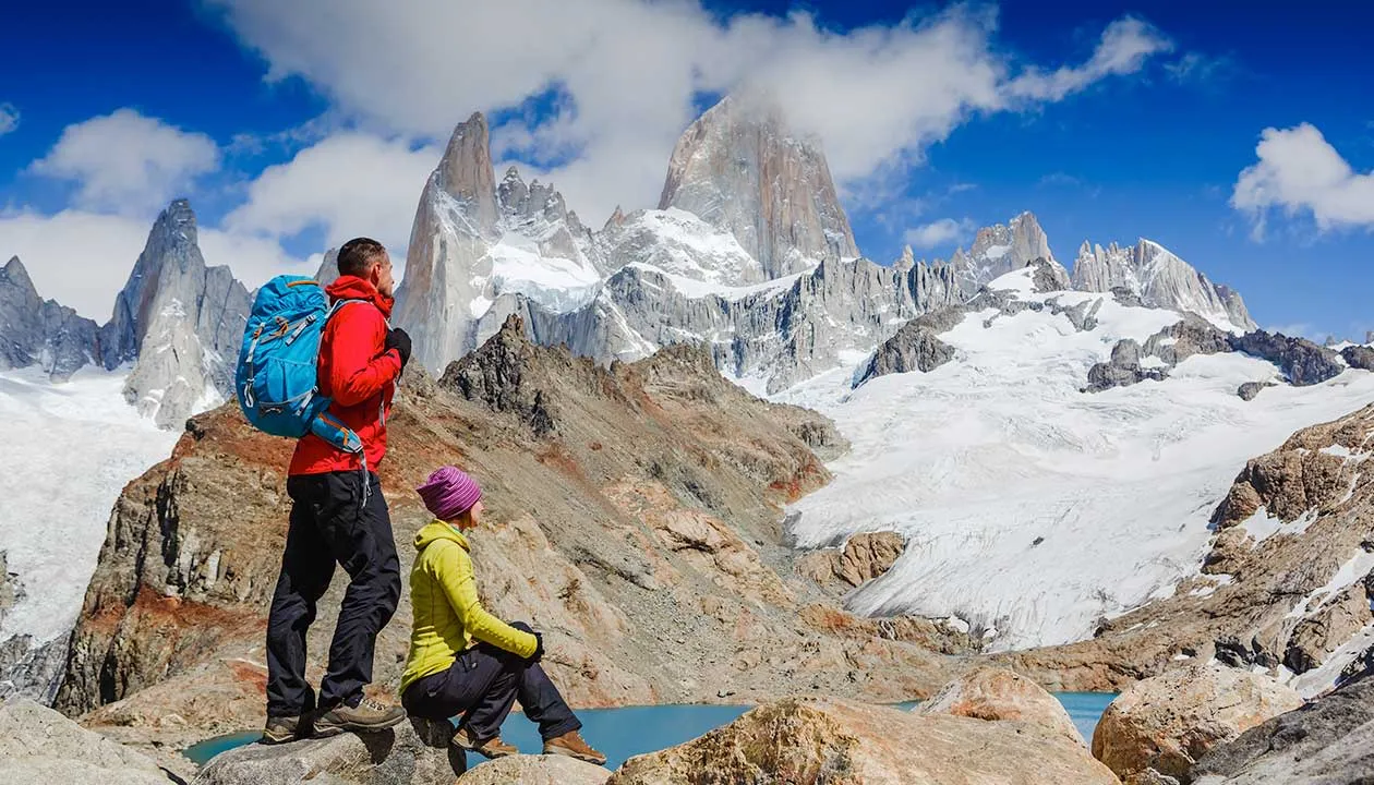 couple hiking in patagonia on a sunny day