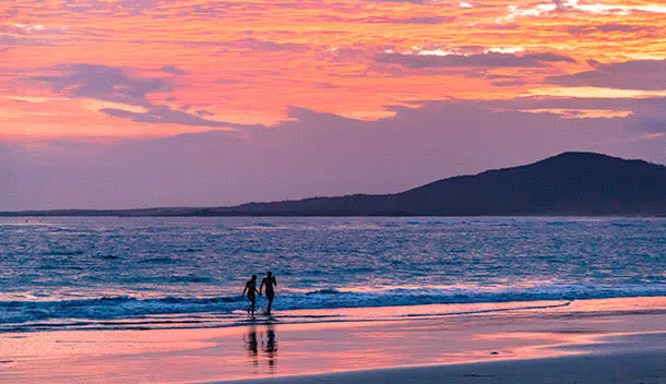 couple walking at sunset in the galapagos