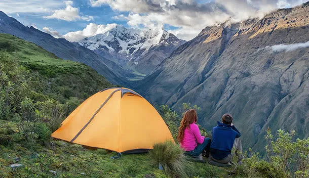 couple hiking and camping in the peruvian andes